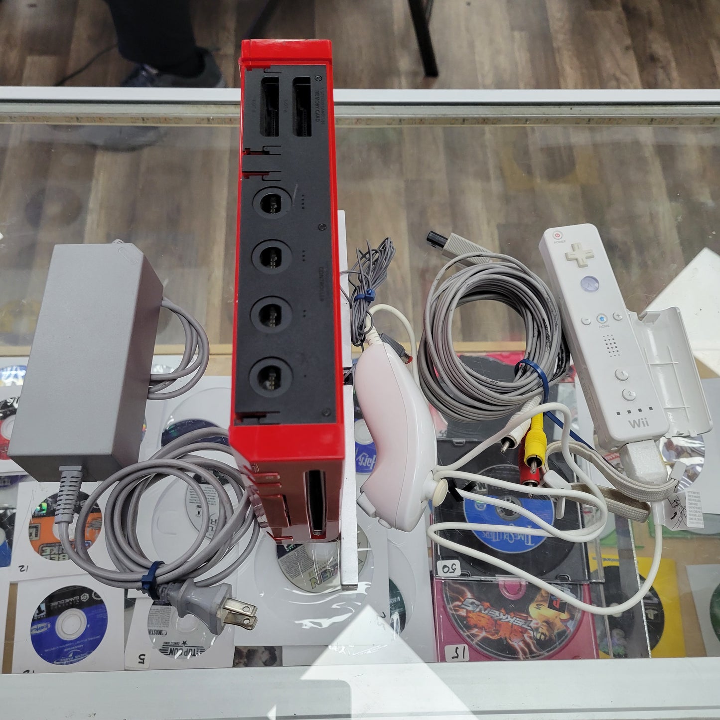 Red Nintendo Wii System with controllers and cables