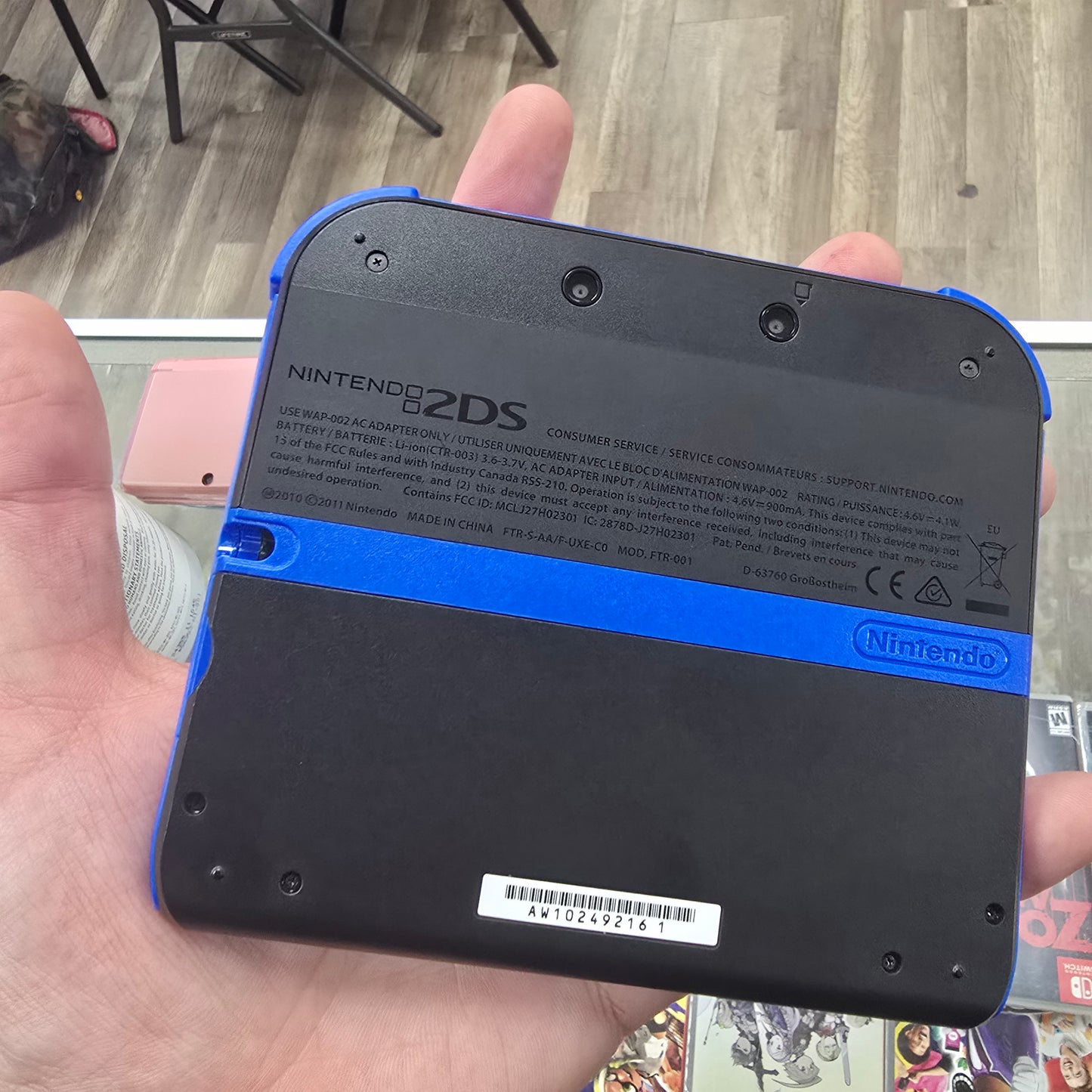 Blue and Black Nintendo 2DS Handheld System with Charger