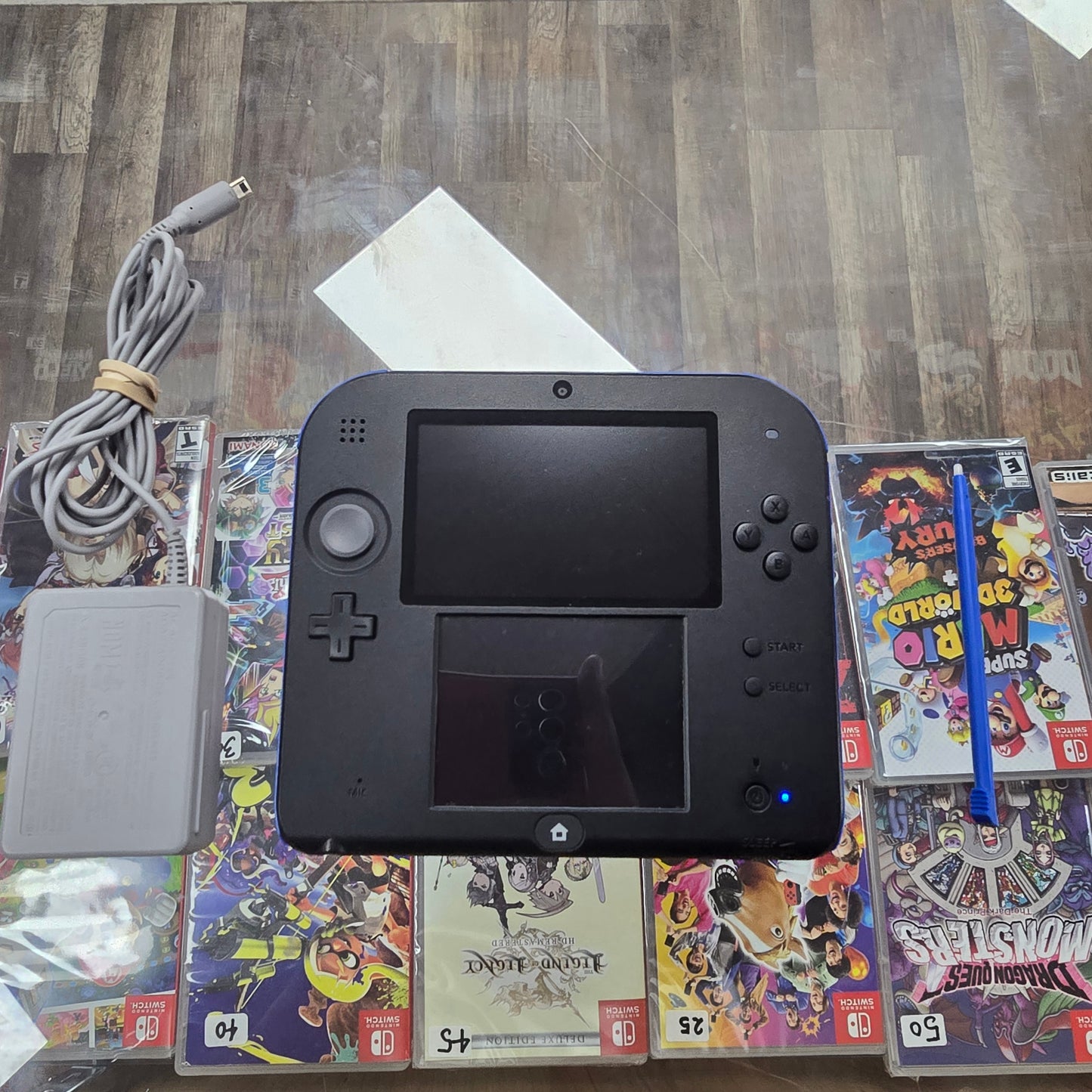 Blue and Black Nintendo 2DS Handheld System with Charger